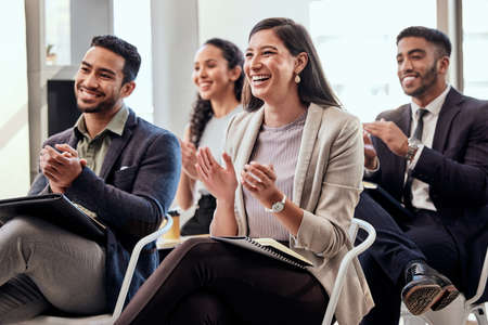 The applause speaks for itself. Shot of a group of businesspeople clapping hands in a meeting at work.の写真素材