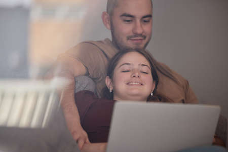 Spending time with you is the best. Shot of a young couple relaxing and watching movies on a laptop.