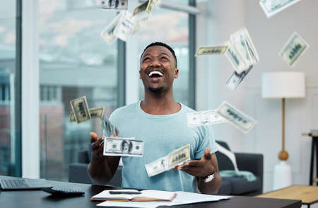 Hes a master money manager. Shot of a young businessman managing his money at home.