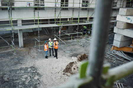 The construction business is booming. Shot of a group of building contractors having a discussion...