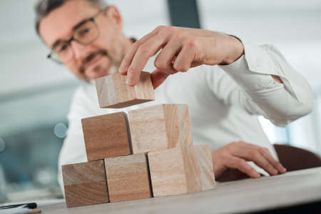 Start building your future from now. Shot of an unrecognisable businessman sitting alone in his...