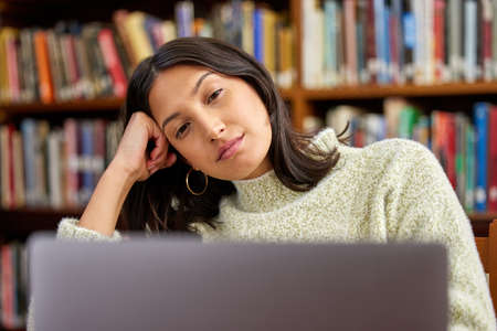Dont let fear of failure put you off. Shot of a hispanic female using a laptop and being stressed in...