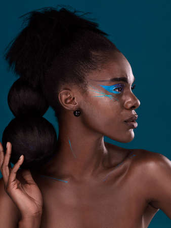When in doubt add a bit of colour. Studio shot of a beautiful young woman posing against a dark...