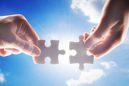 Connecting the pieces. Cropped shot of hands holding two puzzle pieces.