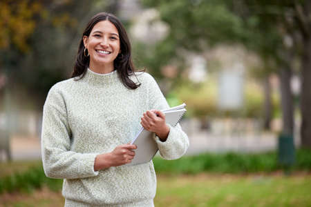 Ready to craft a new career. Portrait of a young woman carrying her schoolbooks outside at college.