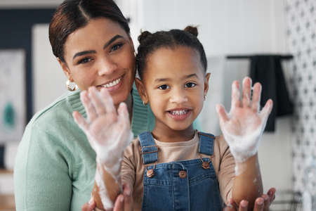 Protecting kids against disease puts moms mind at ease. Shot of a young woman helping her daughter wash her hands at home.の写真素材
