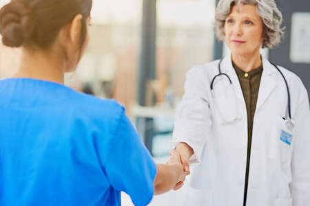 Partnering up for the protection and preservation of your health. Shot of a doctor and nurse shaking hands.の写真素材
