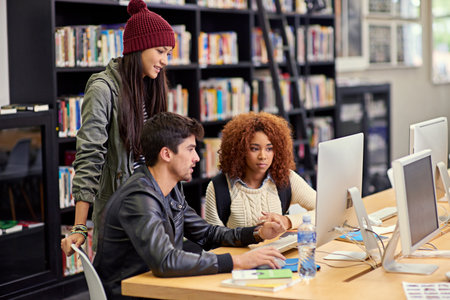 This study group knows what theyre doing. Shot of a group of students working together at a computer...