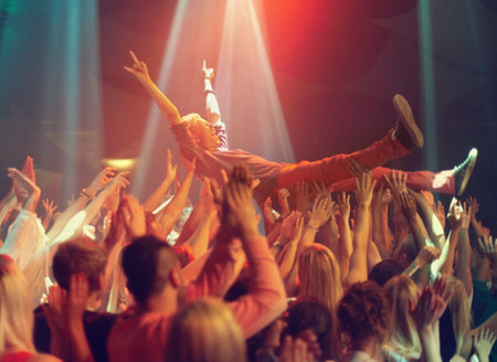 A young man crowd surfing to his favorite band. This concert was created for the sole purpose of this photo shoot, featuring 300 models and 3 live bands. All people in this shoot are model released.の写真素材