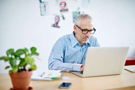 Shot of a handsome businessman working on his laptop. The commercial designs displayed in this image...