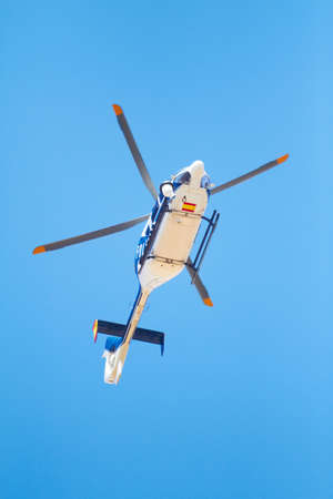 Canvasing the area. Low angle shot of a police helicopter in the sky.の写真素材
