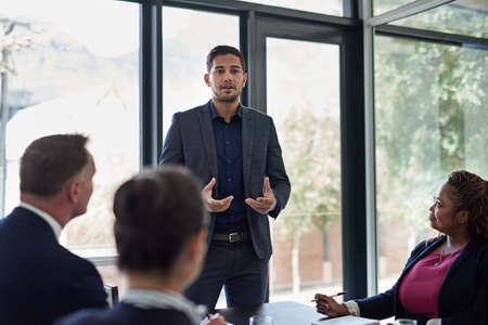 Ironing out the details. Shot of corporate businesspeople meeting in the boardroom.の写真素材