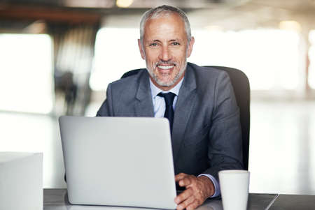 Business has been good to me. Cropped portrait of a mature businessman working in his office.