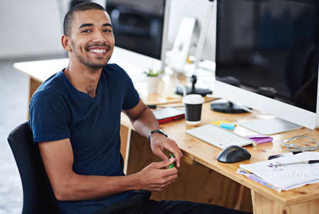 Make creativity a job. Portrait of a young designer at work on his computer.の写真素材