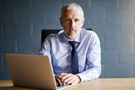 Serious about business. Cropped portrait of a mature businessman working in his office.