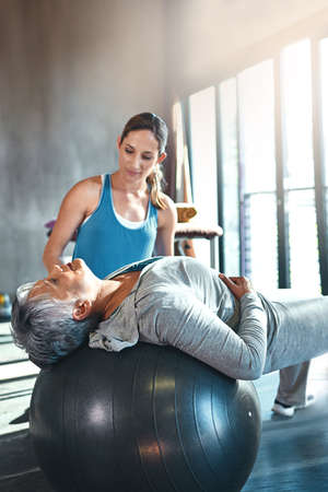 Committed to keeping active and strong at any age. Shot of a senior woman working out with her...