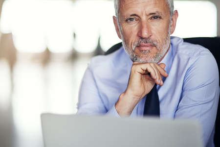 I put a lot of thought into everything I do. Cropped portrait of a mature businessman working in his office.の写真素材