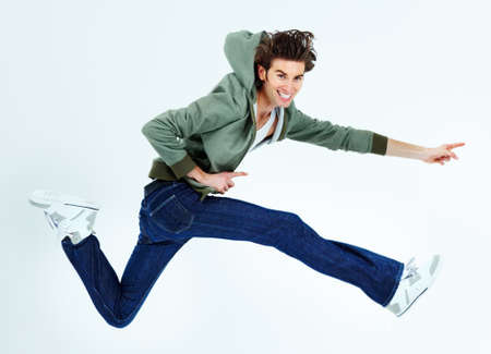 Hes a fun-loving casual kinda guy. Portrait of a young man leaping happily.の写真素材