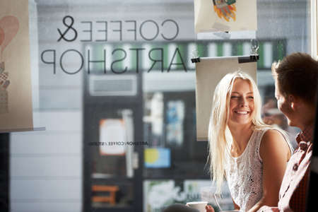 Coffee date. A young couple having a fun date in a coffee shop.