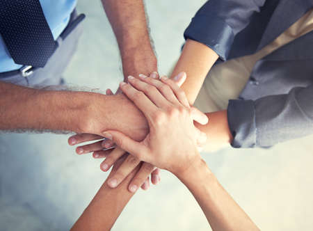 Go team. High angle shot of a business team putting their hands in a huddle.
