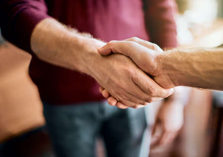 Heres to a successful project. Closeup of two unrecognizable peoples hands greeting and shaking...