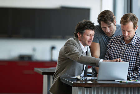 Can we add a feature of here. Cropped shot of three businessman discussing work in the office.