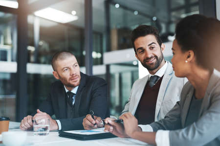 The strategists know how to make it work. Cropped shot of businesspeople working together in the...