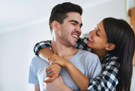 Have I told you lately that I love you. Shot of a happy young couple celebrating their move into a...