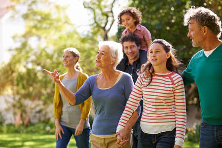Family gathering. Shot of a family walking together outside in the garden.