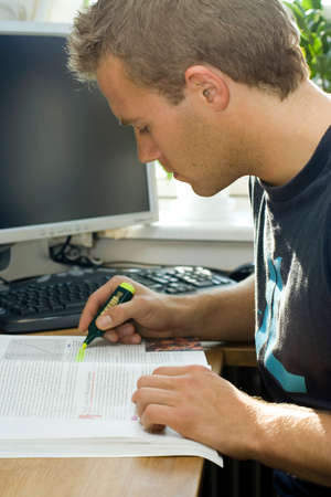 Young man studies. Cropped shot of a young man highlighting important study notes.の写真素材