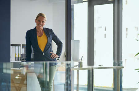 Ive poured my passion into building this business. Portrait of a mature businesswoman standing in an office.の写真素材