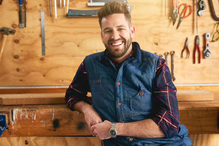 Whatever it is, Im sure I can build it. Portrait of a handsome young handyman standing in his workshop.の写真素材