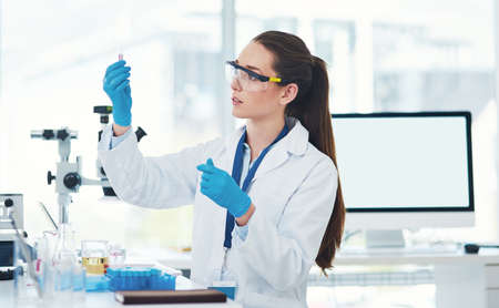 Here it is. Cropped shot of a focused young female scientist mixing chemicals together inside of a...