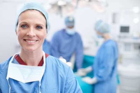 Laughter and happiness are the best medicine. Portrait of a mature female doctor smiling in an operating room.の写真素材