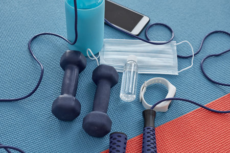 Healthy isnt a goal, its a way of living. Studio shot of a variety of workout equipment and PPE on a...