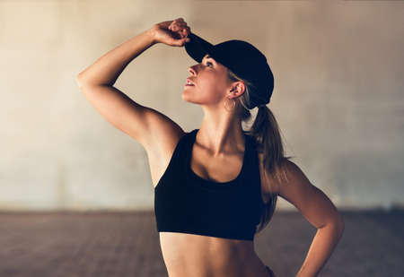 Looking for some inspiration. Shot of an attractive young female street dancer practising out in the city.の写真素材