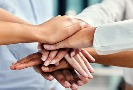 United in their pursuit of success. Cropped shot of a group of unrecognizable businesspeoples hands...