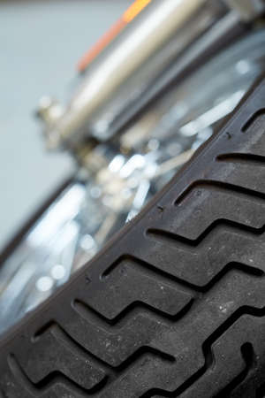 Closeup tilted view of a motorbike tire. Tires designed for custom modern sports bike. Suspension on...