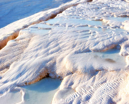 Closeup of travertine pools and terraces in Pamukkale, Turkey. Traveling abroad for vacation and...