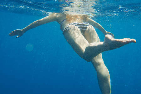 Shot of an unrecognisable woman swimming in the Mediterranean Sea in Italyの写真素材