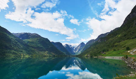Majestic beautiful fjord landscape in Norway Fjord lake mountain snow water reflection glacial...