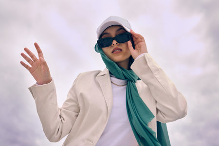Beautiful young arab woman posing outdoors in a headscarf. Attractive female muslim wearing a hijab...