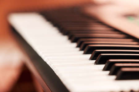 Closeup shot of black and white piano keys. Above shot of a sharp and flat piano keys. Music can...