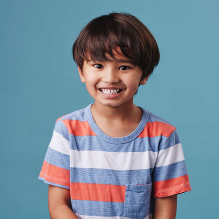 Portrait of a cute little asian boy wearing casual clothes while smiling and looking excited. Child...