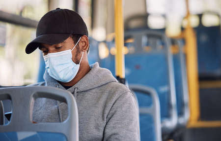 Mixed race man travelling by bus in the city. Mixed race man travelling by bus in the city.の写真素材