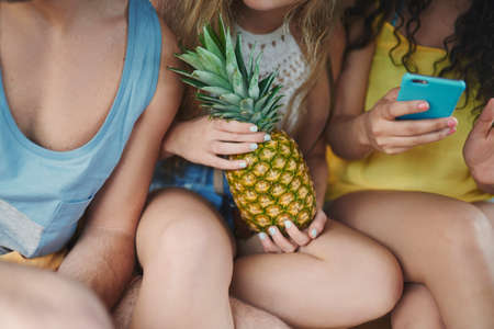 Follow us for an awesome summer adventure. Shot of a group of young friends taking selfies with a...