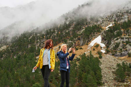 Mother nature has the best box of crayons. Shot of two friends having fun outside.