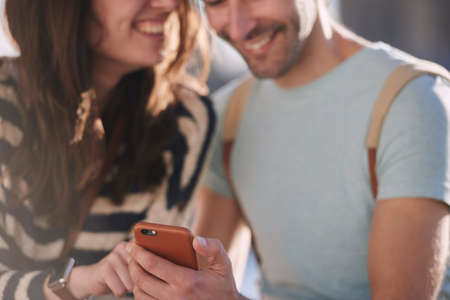 Shot of an unrecognisable couple using a smartphone while exploring the city of London.の写真素材