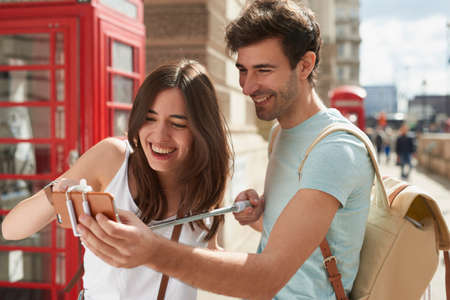 Live, Love, London. Shot of a young couple looking at a map while exploring the city of London.の写真素材