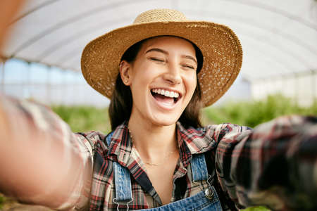 A smile goes a long way. Shot of a young female farmer taking selfies.の写真素材